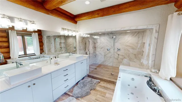 a spacious bathroom with a tub sink and mirror