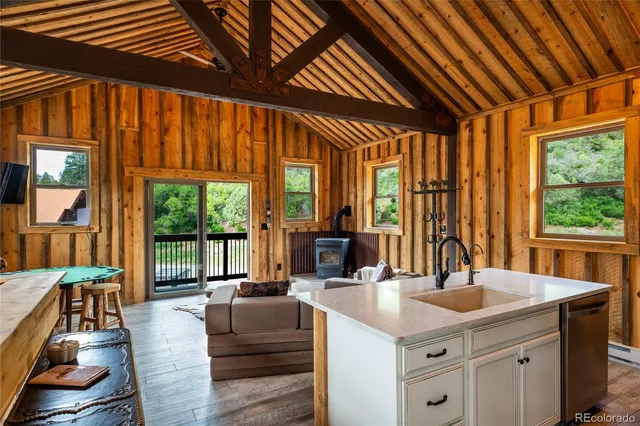 a living room with furniture a wooden floor and next to a window