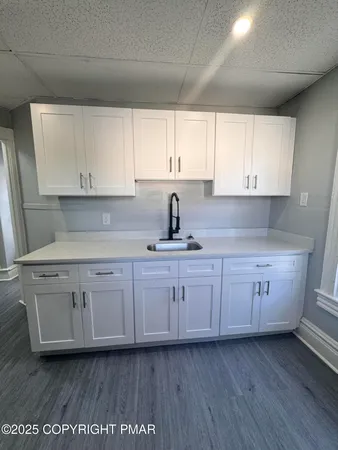 a stove top oven sitting inside of a kitchen