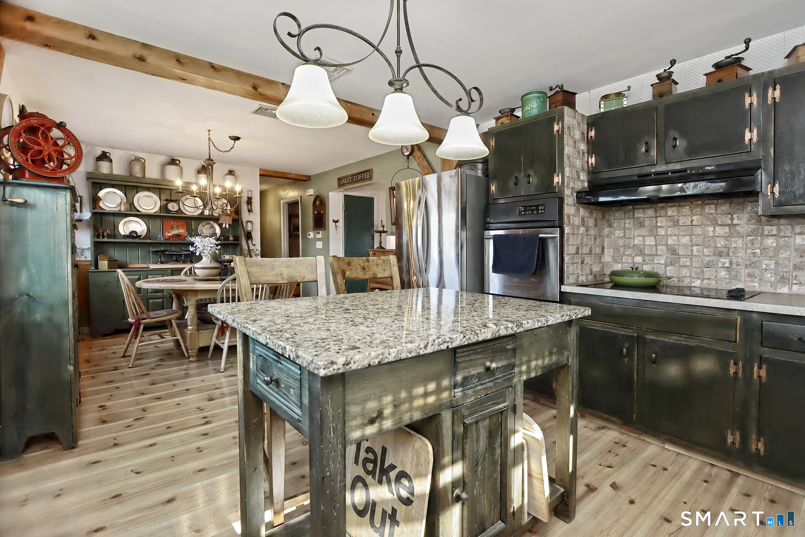 6 Mt Pleasant Road West Haven, CT 06516 - Photo 12 of 40 a kitchen with stainless steel appliances granite countertop a table chairs and a refrigerator