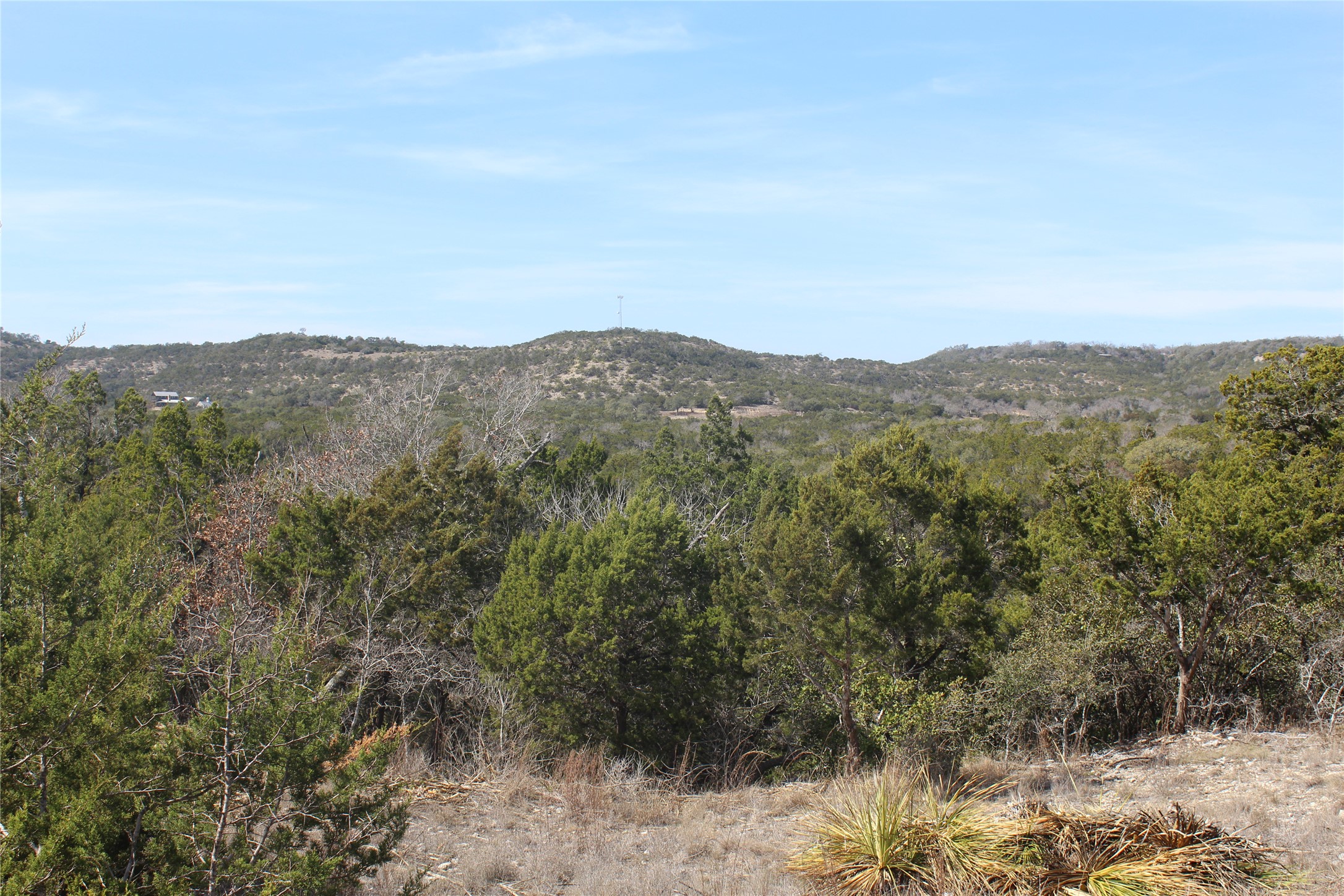 2102 Montell Road Wimberley, TX 78676 - Photo 3 of 18 a view of a mountain range in a cloudy sky