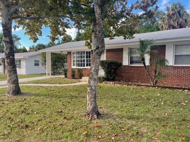 2501 Sheridan Road Mount Dora, FL 32757 - Photo 1 of 21 a front view of a house with a yard