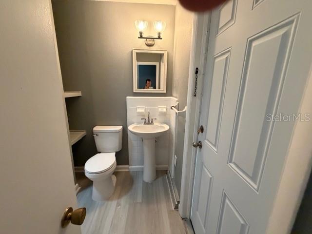 2501 Sheridan Road Mount Dora, FL 32757 - Photo 16 of 21 a bathroom with a toilet a sink and mirror
