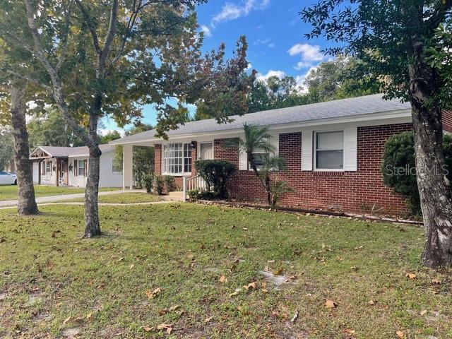 2501 Sheridan Road Mount Dora, FL 32757 - Photo 3 of 21 a view of a house with backyard and a tree