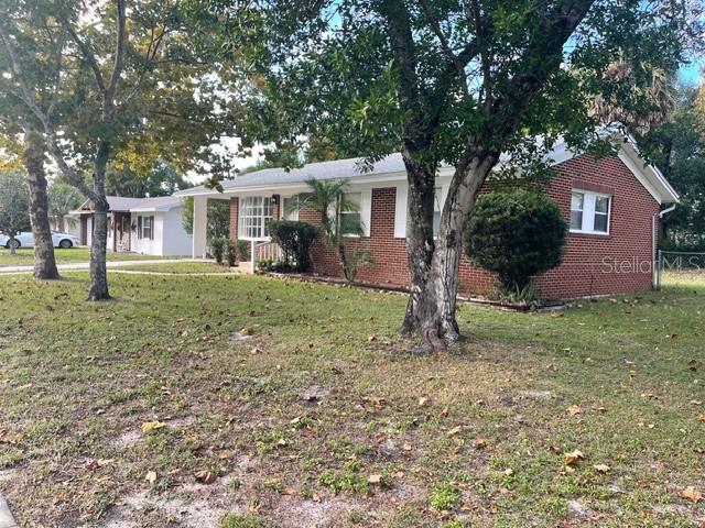 2501 Sheridan Road Mount Dora, FL 32757 - Photo 4 of 21 a front view of a house with garden