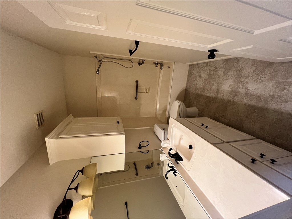 2619 Trophy Drive Bryan, TX 77802 - Photo 13 of 25 a bathroom with a double vanity sink mirror and a toilet