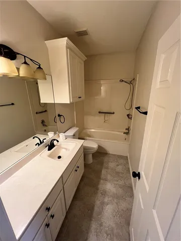 a bathroom with a double vanity sink mirror and a toilet