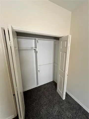 an empty room with wooden floor and entrance