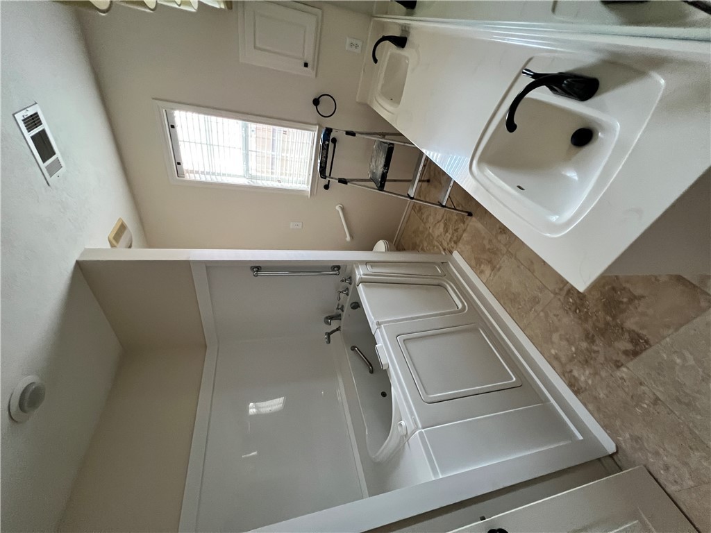 2619 Trophy Drive Bryan, TX 77802 - Photo 22 of 25 a bathroom with a sink and a tub