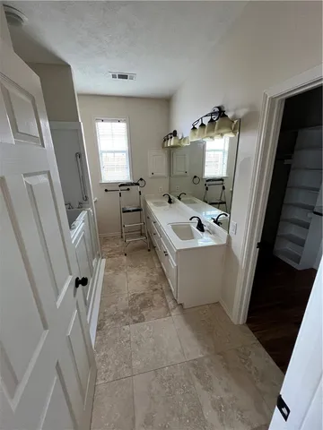 a view of walk in closet with empty racks