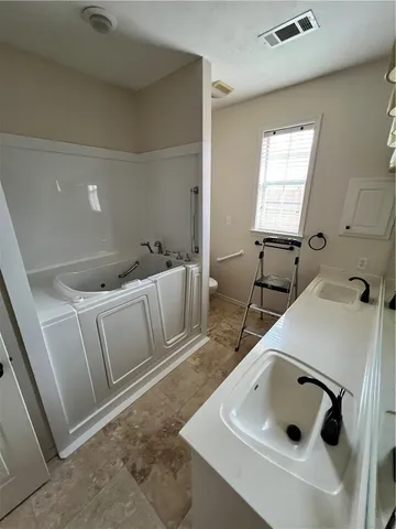 a bed in a room next to a window