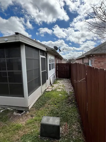 a view of a house with a large window and a yard
