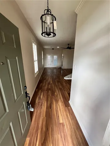 a view of a room with wooden floor and stainless steel appliances