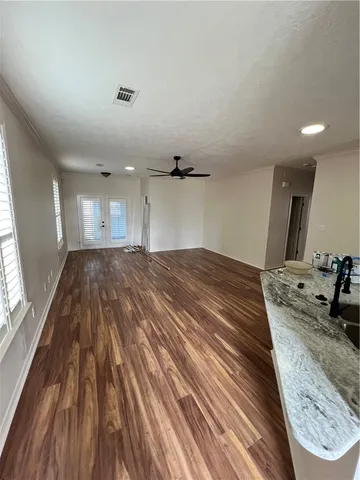 a spacious bedroom with a bed and a large window