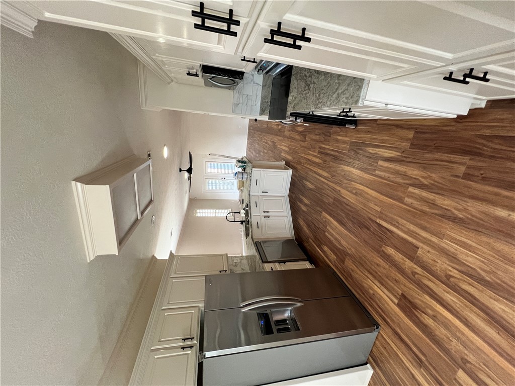 2619 Trophy Drive Bryan, TX 77802 - Photo 10 of 25 a open kitchen with cabinets a sink and wooden floor