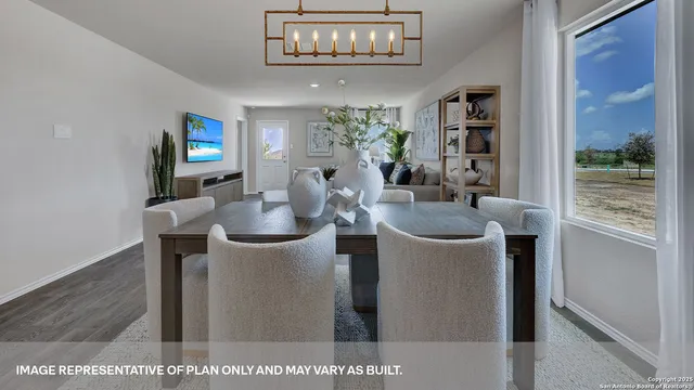 a dining room with furniture and a floor to ceiling window