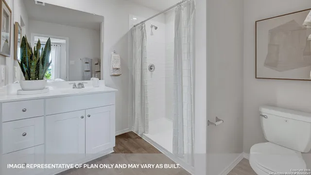 a bathroom with a toilet a sink and a mirror