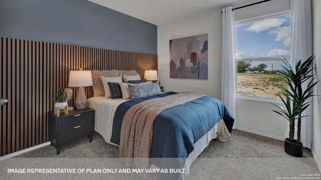 a bed room with a bed and a potted plant