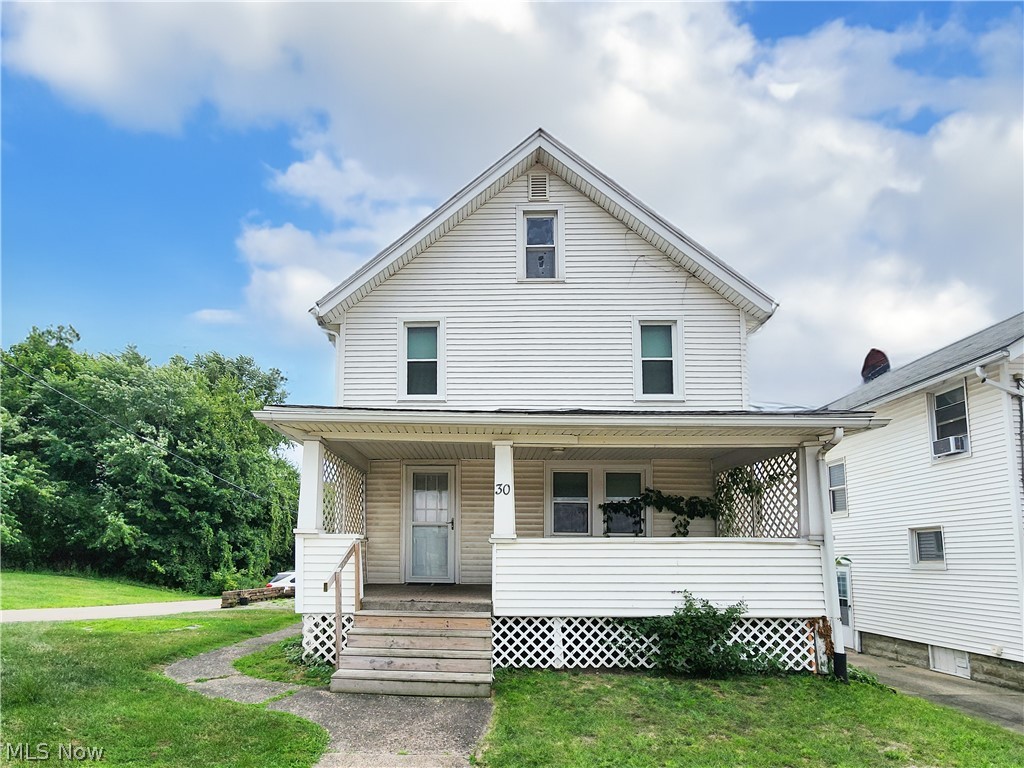 30 West Wilbeth Road, Unit A Akron, OH 44301 - Photo 1 of 16 View of front of home with covered porch and a front lawn