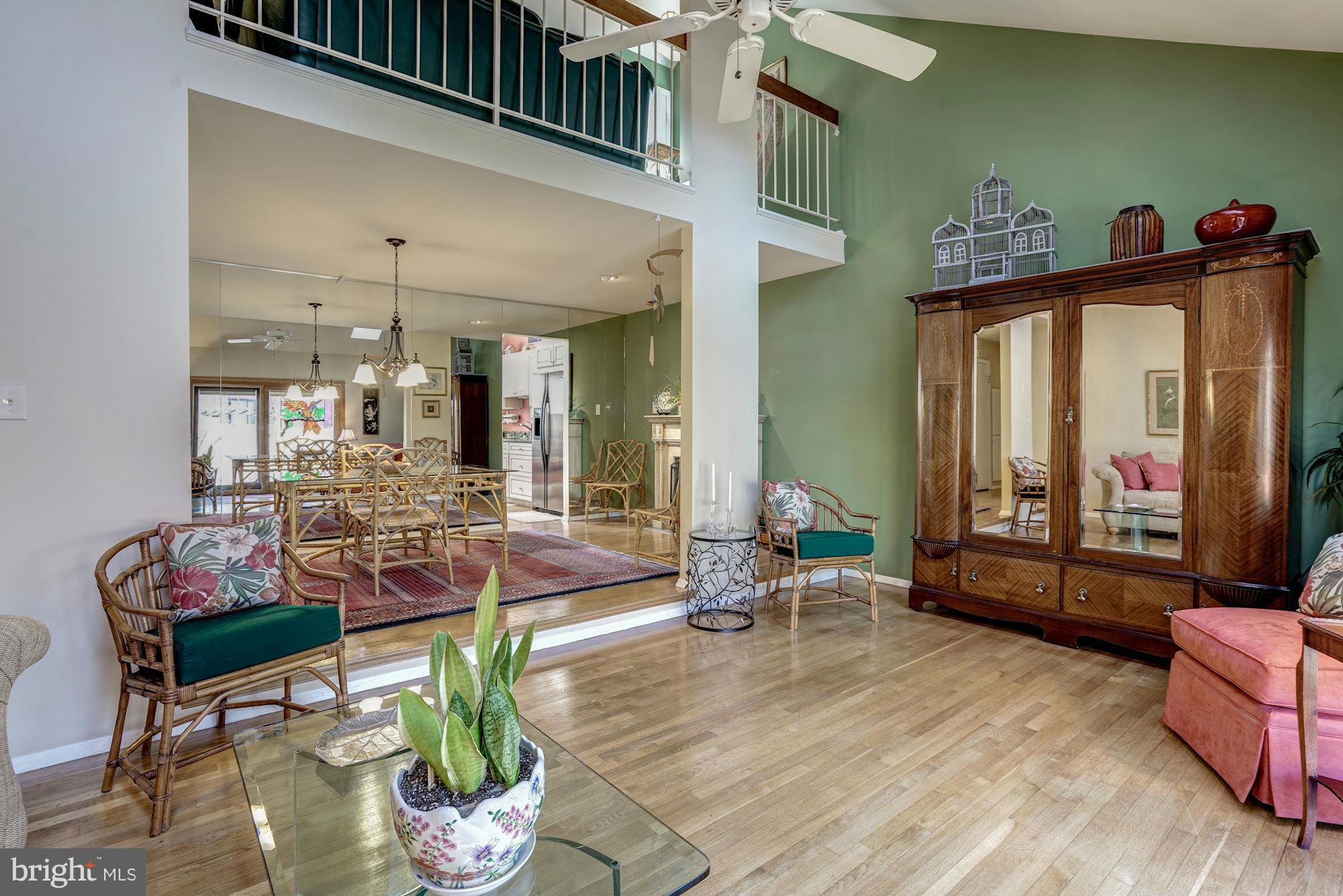 1416 Green Run Lane Reston, VA 20190 - Photo 12 of 29 a living room with furniture a fireplace and a flat screen tv
