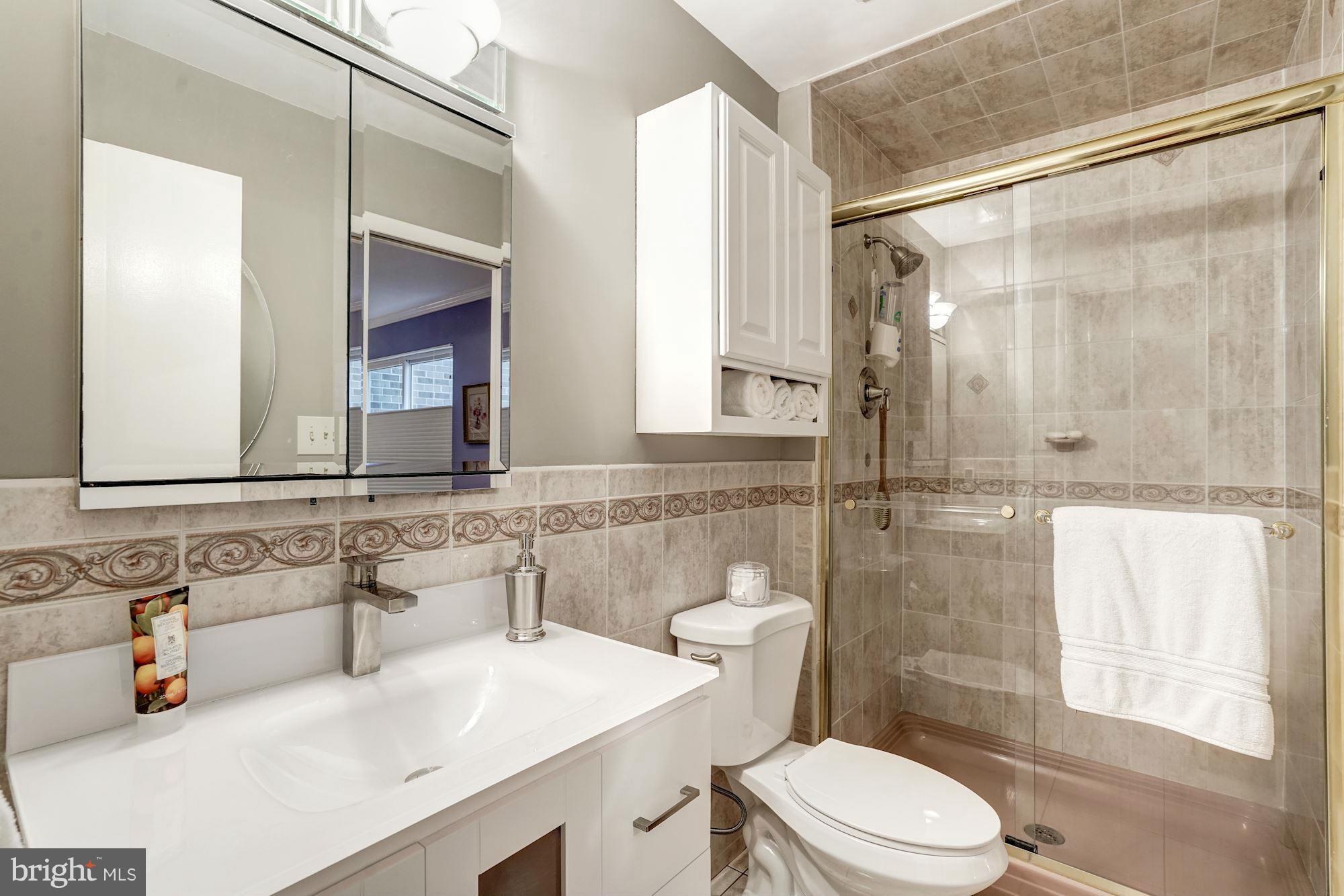 1416 Green Run Lane Reston, VA 20190 - Photo 16 of 29 a bathroom with a sink toilet vanity and shower
