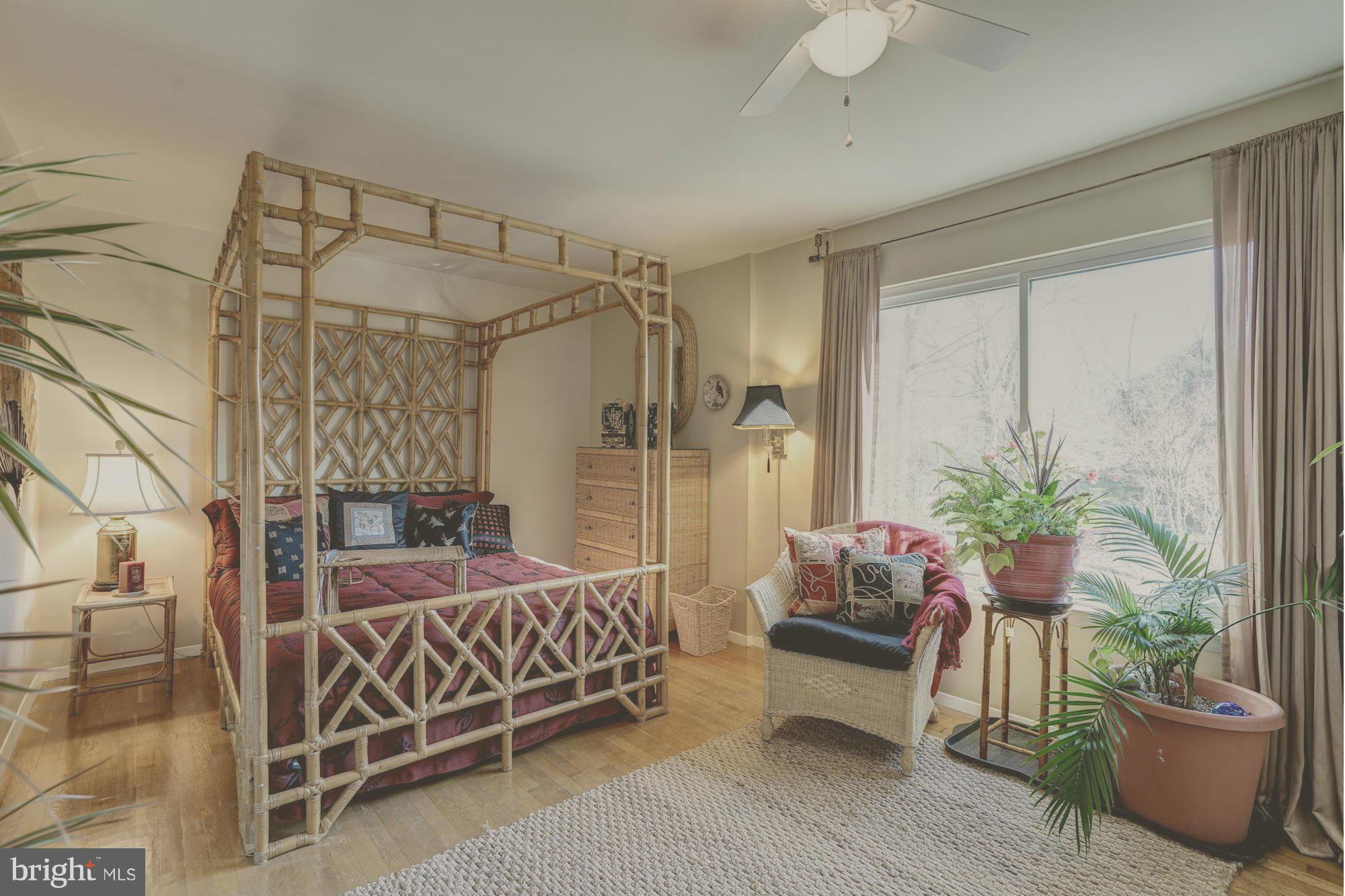 1416 Green Run Lane Reston, VA 20190 - Photo 19 of 29 a bedroom with a bed and a potted plant
