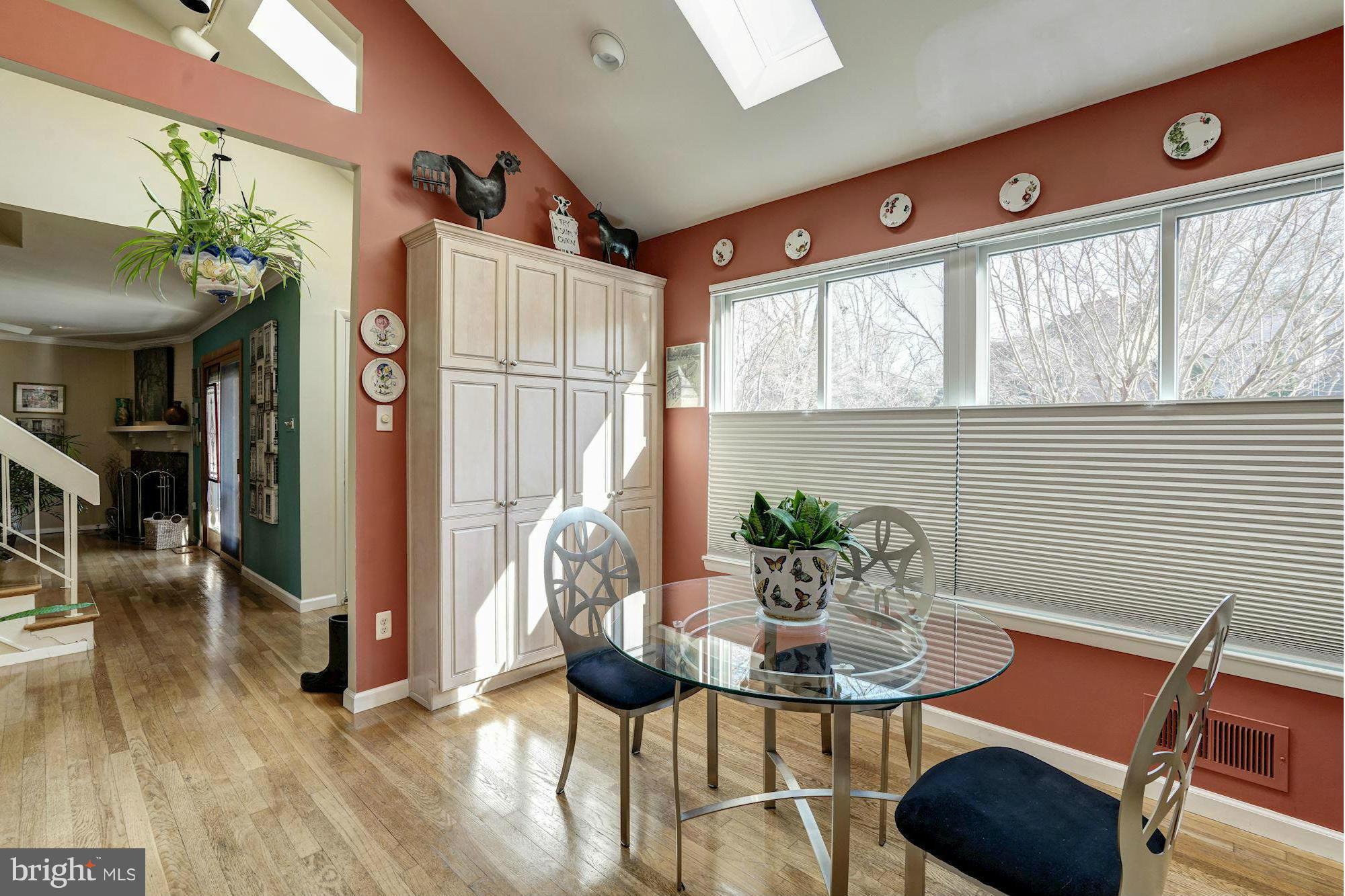 1416 Green Run Lane Reston, VA 20190 - Photo 5 of 29 a dining room with furniture potted plants and wooden floor