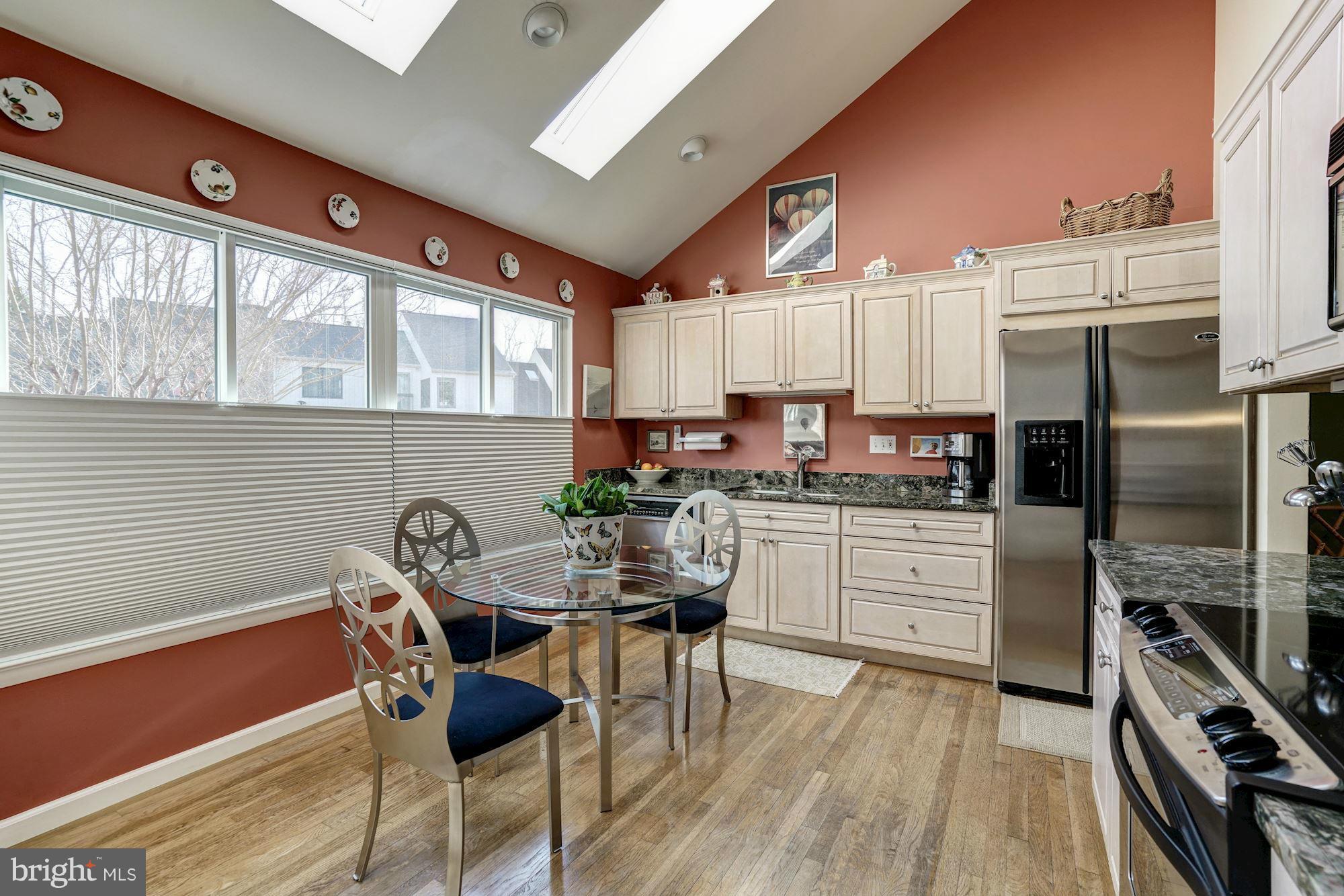 1416 Green Run Lane Reston, VA 20190 - Photo 6 of 29 a kitchen with a table chairs a refrigerator and cabinets
