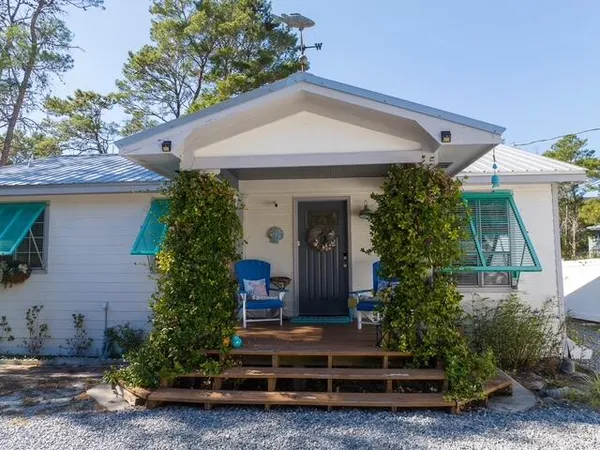 a front view of a house with a yard garage and outdoor seating