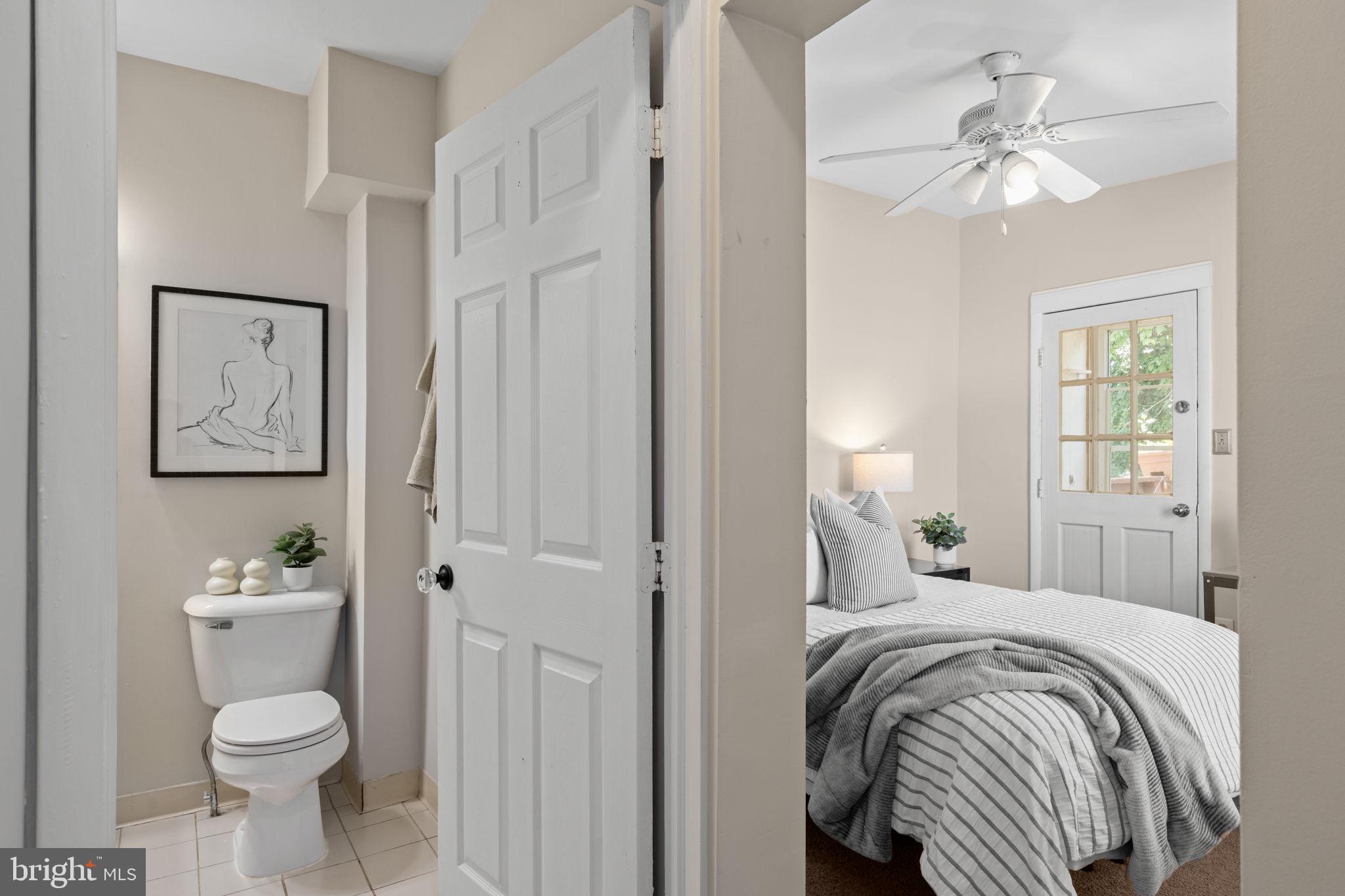 4092 Pechin Street Philadelphia, PA 19128 - Photo 16 of 28 a bedroom with a bed and a chandelier