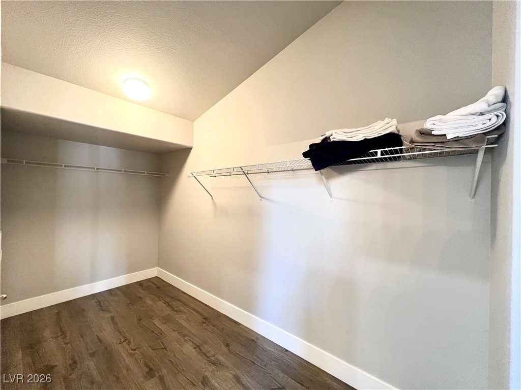 2218 Armacost Drive Henderson, NV 89074 - Photo 21 of 31 Spacious closet featuring vaulted ceiling and dark wood-style floors