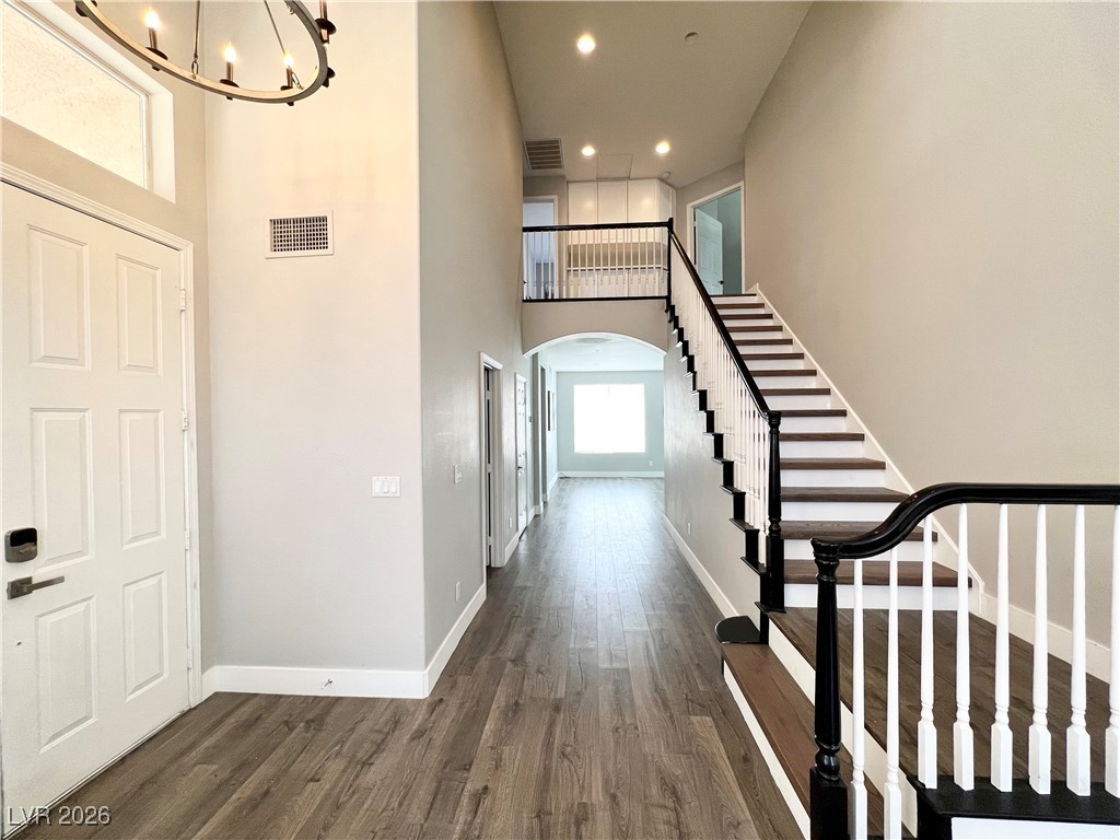 2218 Armacost Drive Henderson, NV 89074 - Photo 3 of 31 Foyer entrance featuring a high ceiling, dark wood finished floors, a chandelier, and recessed lighting
