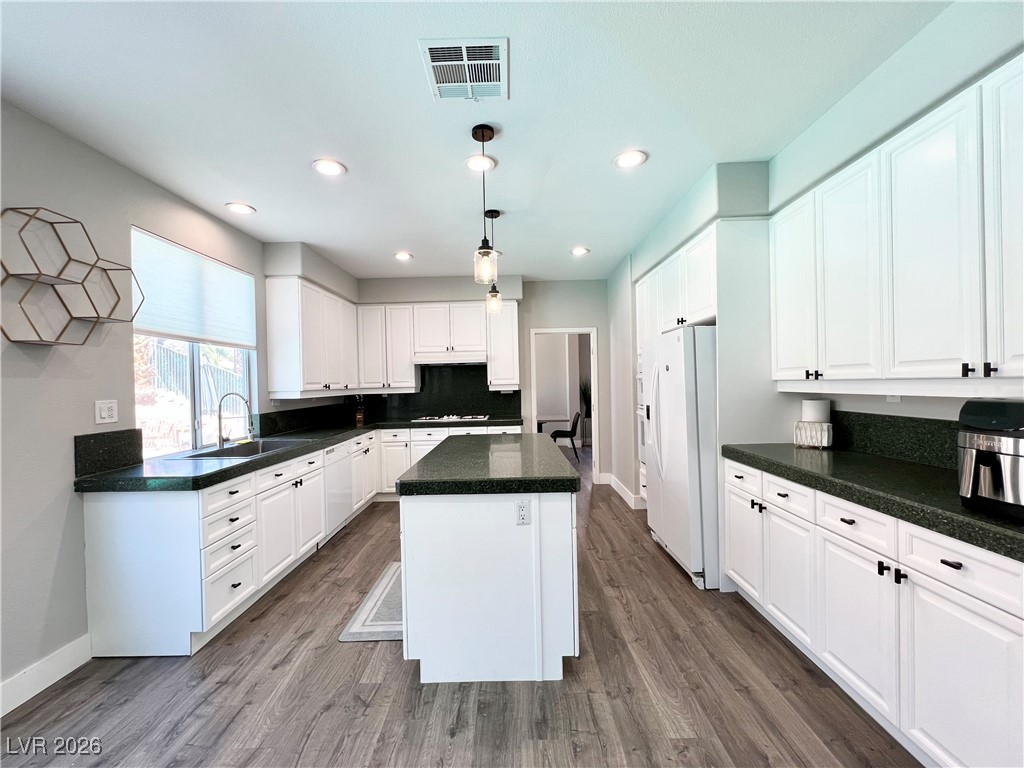 2218 Armacost Drive Henderson, NV 89074 - Photo 4 of 31 Kitchen featuring white cabinets, decorative light fixtures, a kitchen island, white appliances, and recessed lighting