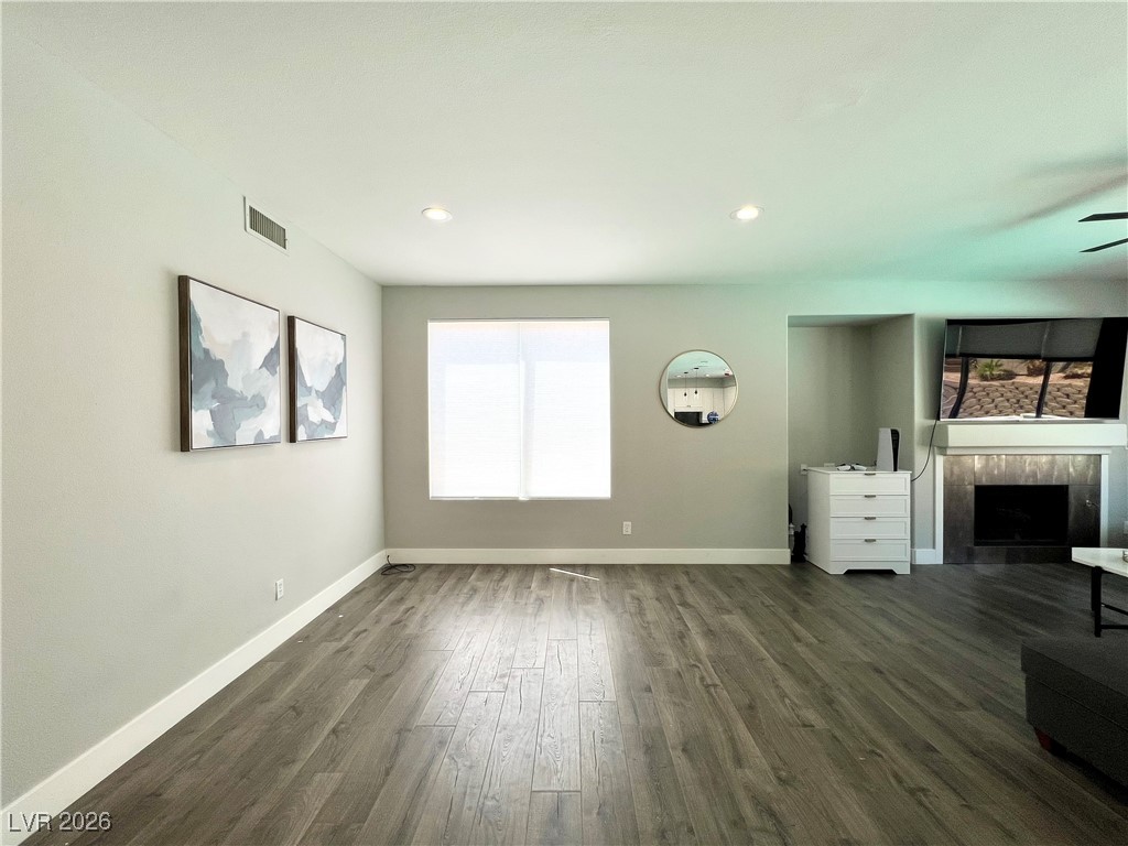 2218 Armacost Drive Henderson, NV 89074 - Photo 8 of 31 Unfurnished living room featuring a tile fireplace, dark wood-type flooring, recessed lighting, and a ceiling fan