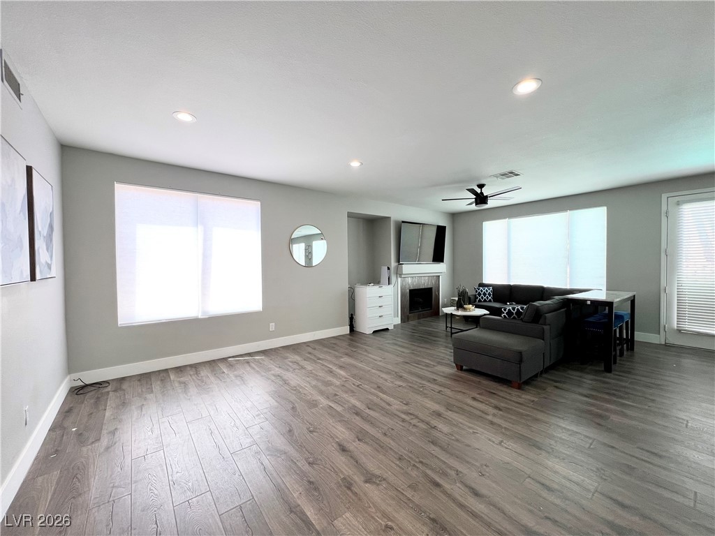 2218 Armacost Drive Henderson, NV 89074 - Photo 9 of 31 Living area featuring a fireplace, wood finished floors, plenty of natural light, recessed lighting, and ceiling fan