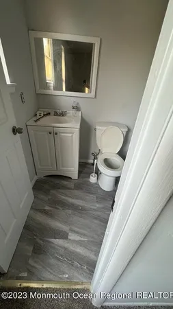 a bathroom with a sink a toilet and mirror
