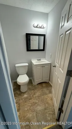 a bathroom with a toilet sink and mirror