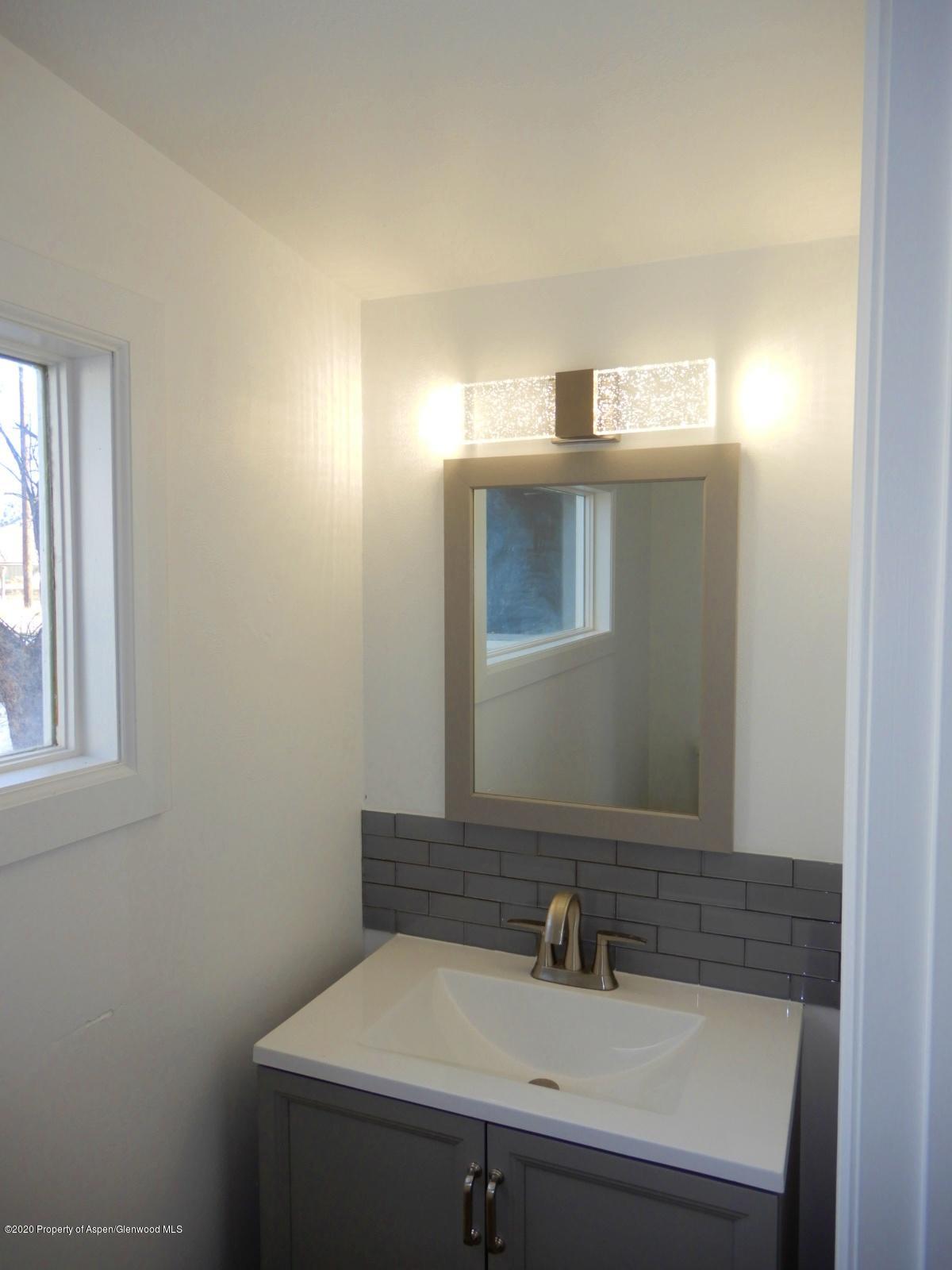 119 June Avenue Rifle, CO 81650 - Photo 13 of 24 a bathroom with a sink and a mirror