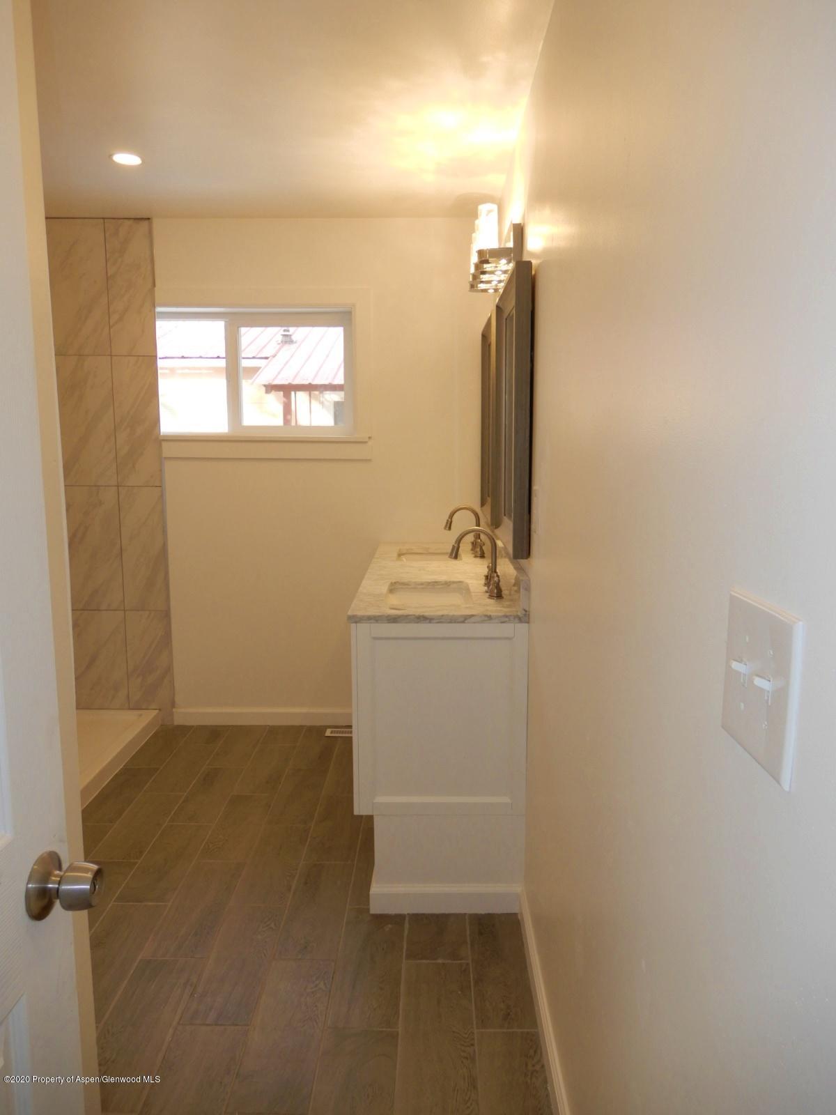 119 June Avenue Rifle, CO 81650 - Photo 23 of 24 a bathroom with a sink a toilet and mirror