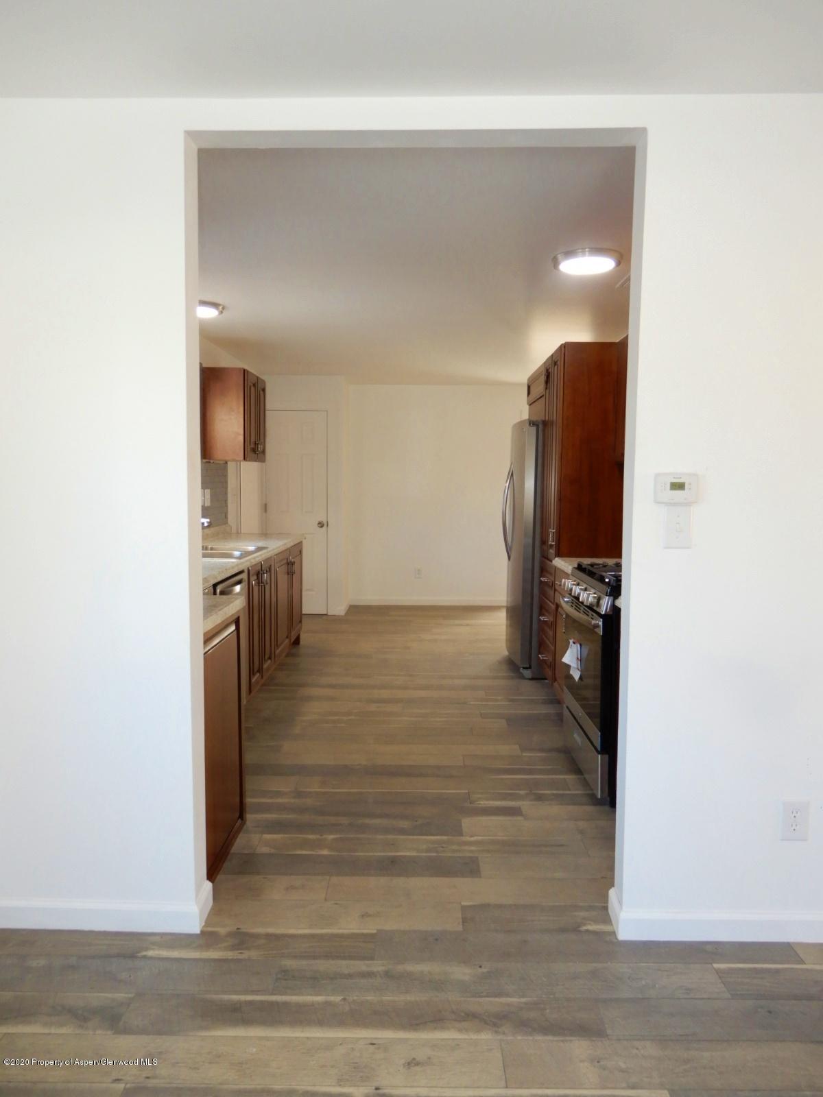 119 June Avenue Rifle, CO 81650 - Photo 9 of 24 a view of a kitchen from the hallway with a large window