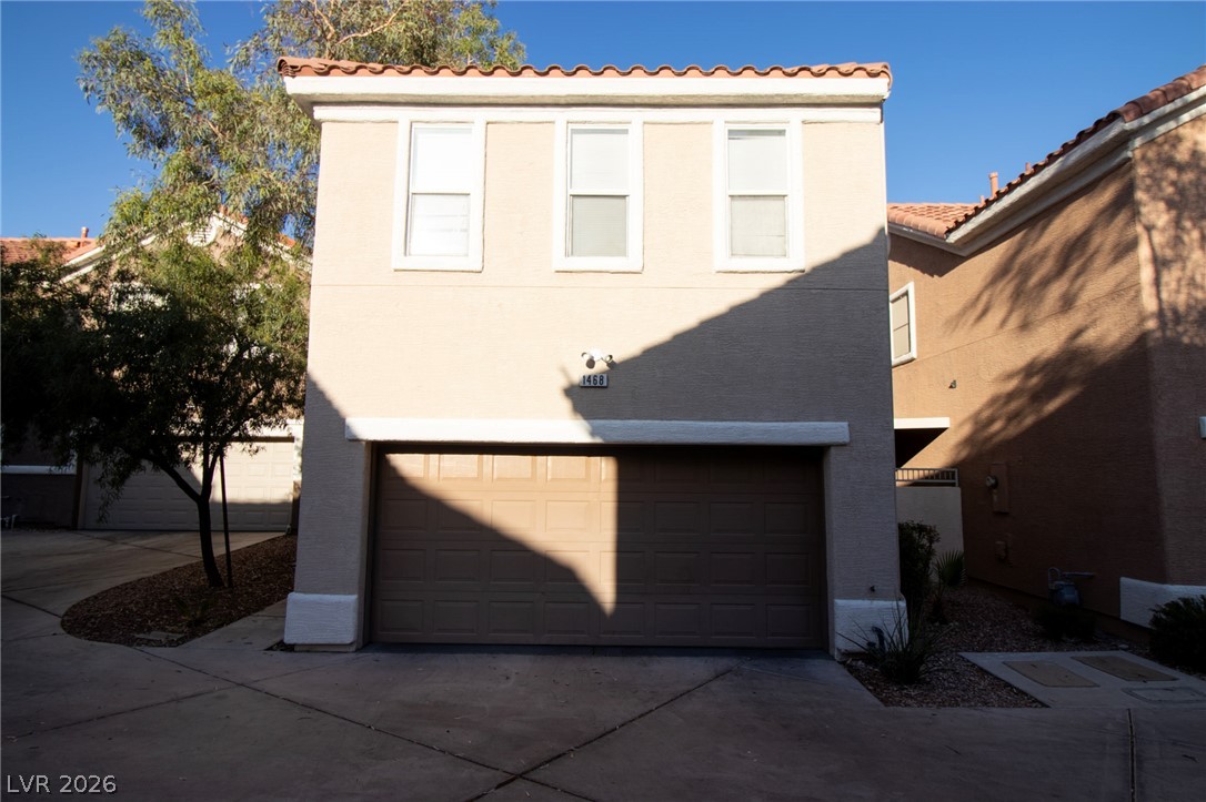 1468 Reef Ridge Court Las Vegas, NV 89128 - Photo 1 of 22 A stucco exterior with a tiled roof provides a pleasing facade to this attached garage residence.