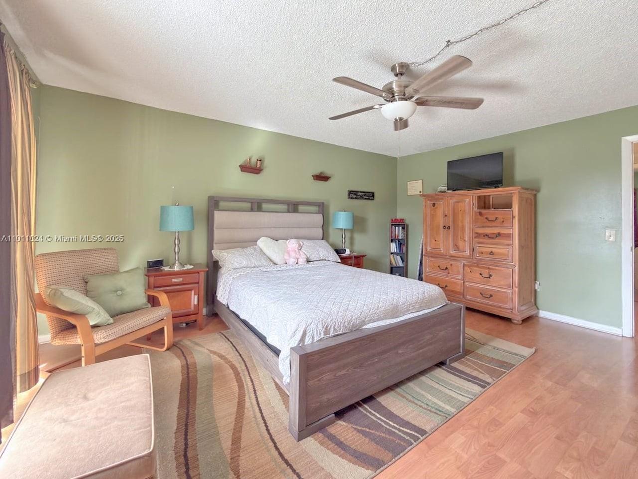6500 Southwest 41st Court, Unit 88 Davie, FL 33314 - Photo 11 of 19 a bedroom with a bed and a ceiling fan
