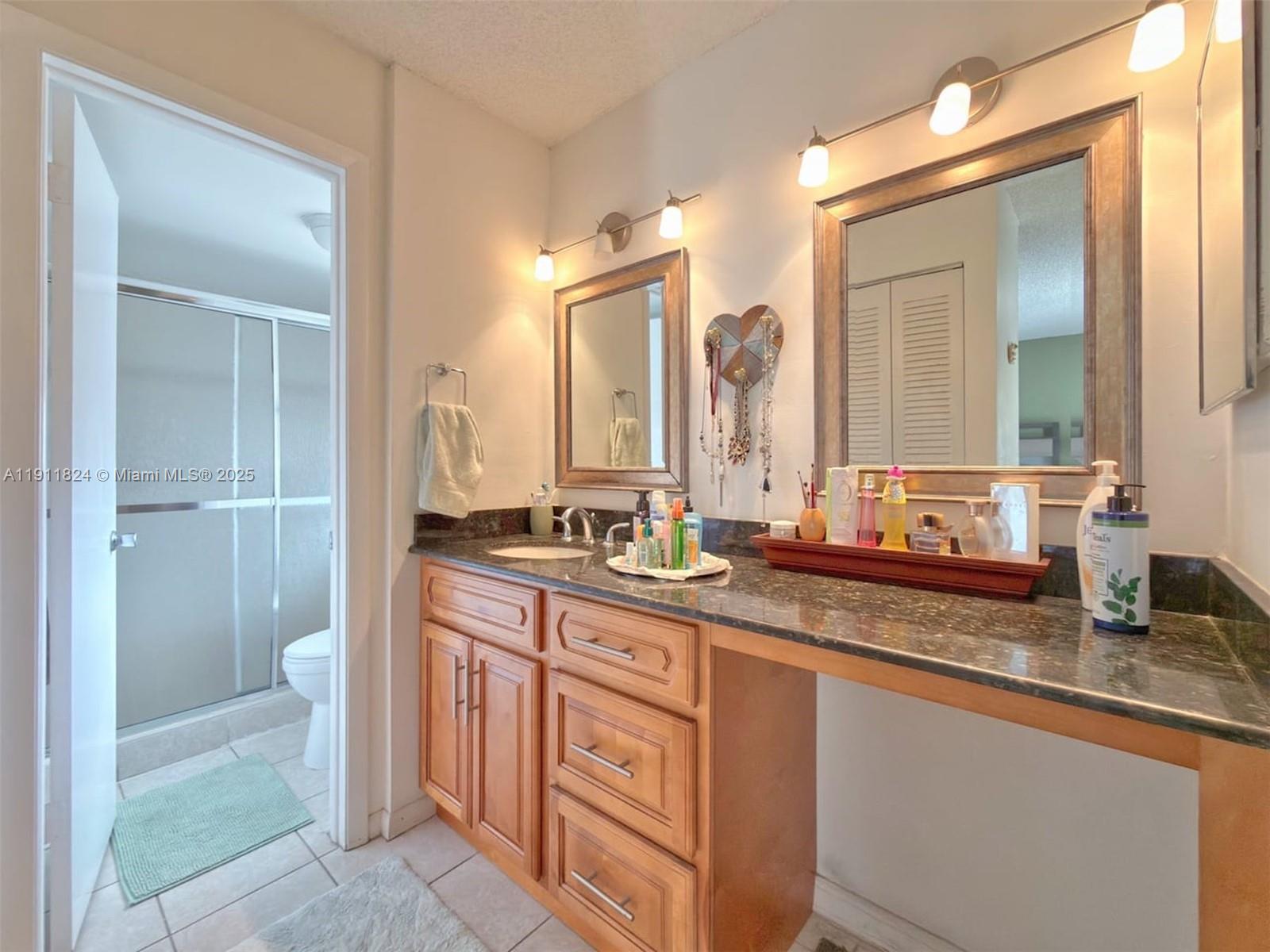 6500 Southwest 41st Court, Unit 88 Davie, FL 33314 - Photo 12 of 19 a bathroom with a granite countertop sink mirror and double
