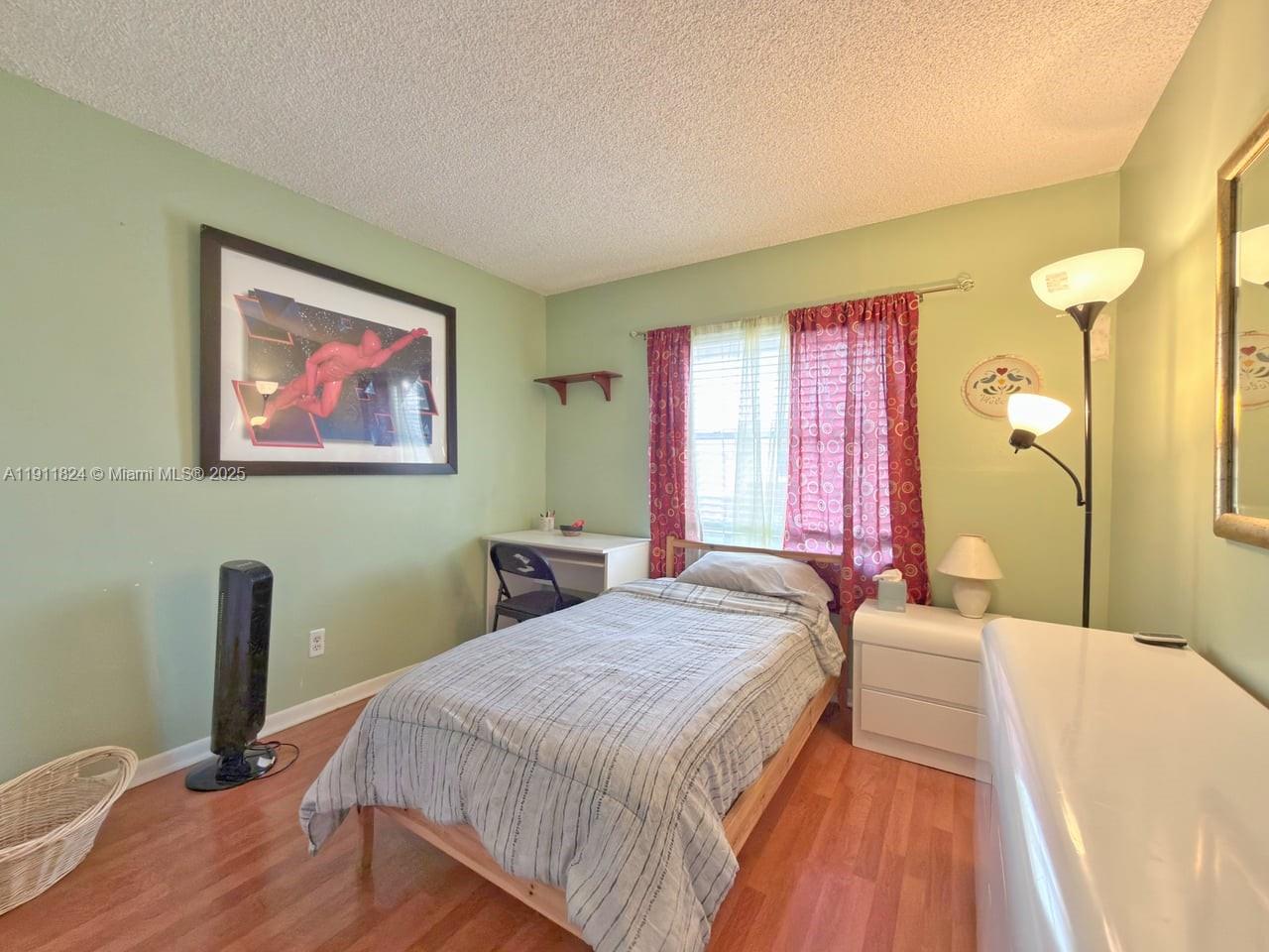 6500 Southwest 41st Court, Unit 88 Davie, FL 33314 - Photo 15 of 19 a bed sitting in a bedroom next to a window