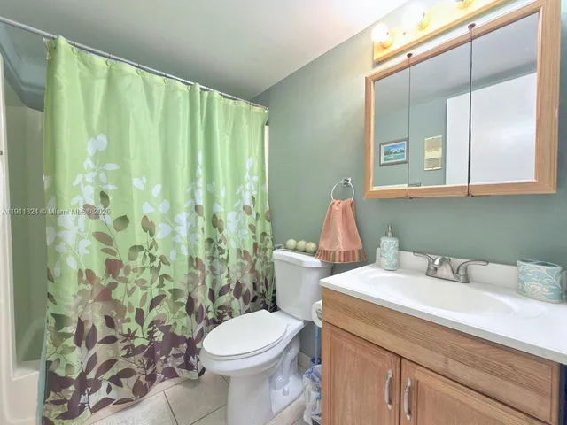 a view of a house with a small yard and deck