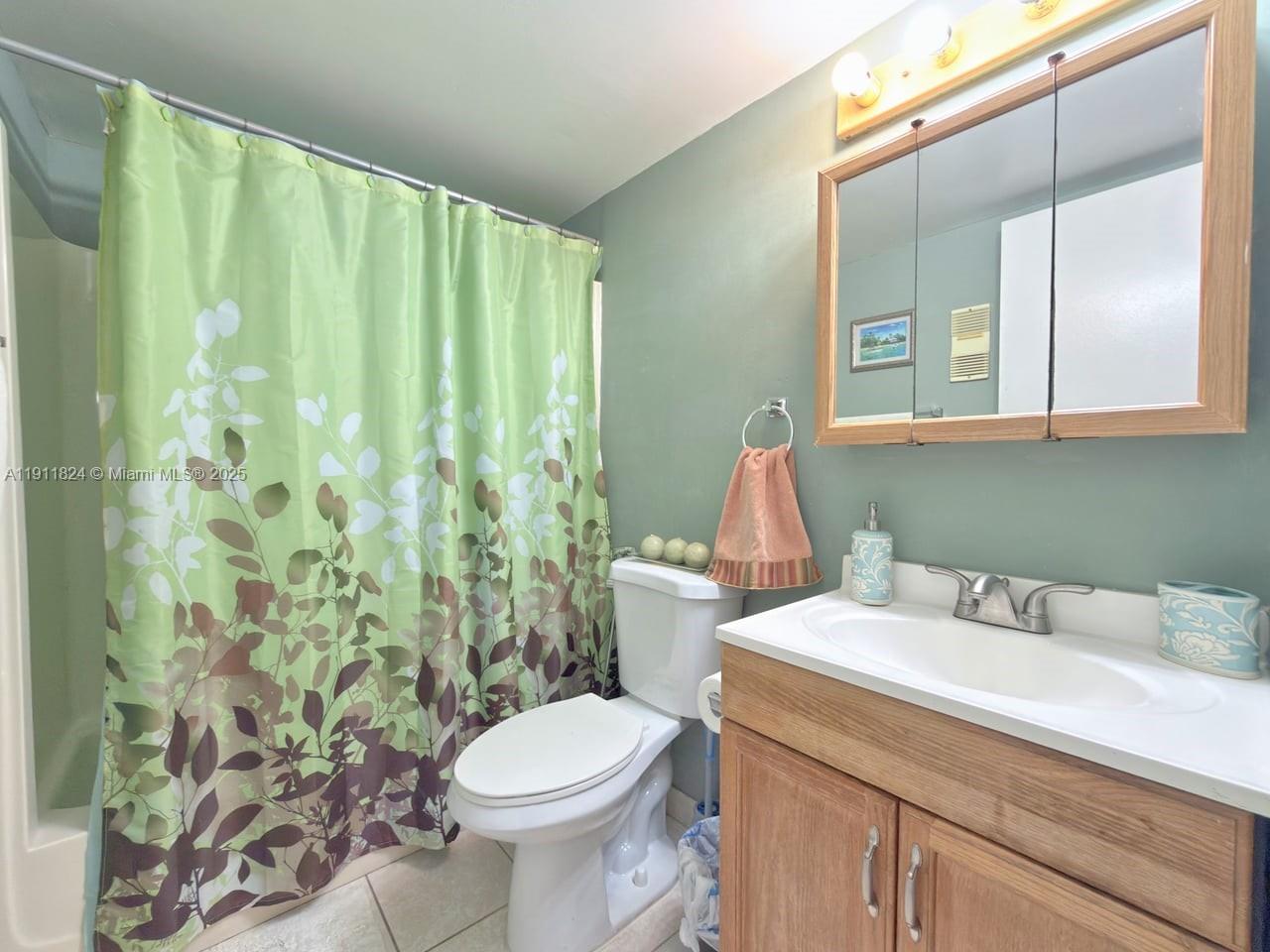 6500 Southwest 41st Court, Unit 88 Davie, FL 33314 - Photo 16 of 19 a bathroom with a sink a toilet and a mirror