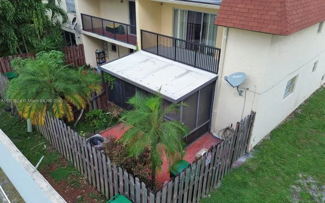 a view of a brick house with a small park