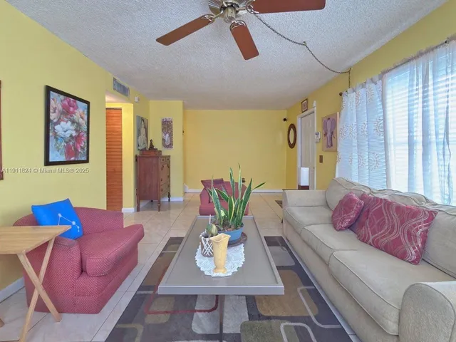 a living room with furniture rug and window