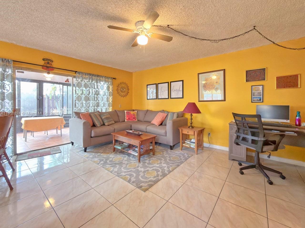 6500 Southwest 41st Court, Unit 88 Davie, FL 33314 - Photo 5 of 19 a living room with furniture a lamp and a potted plant