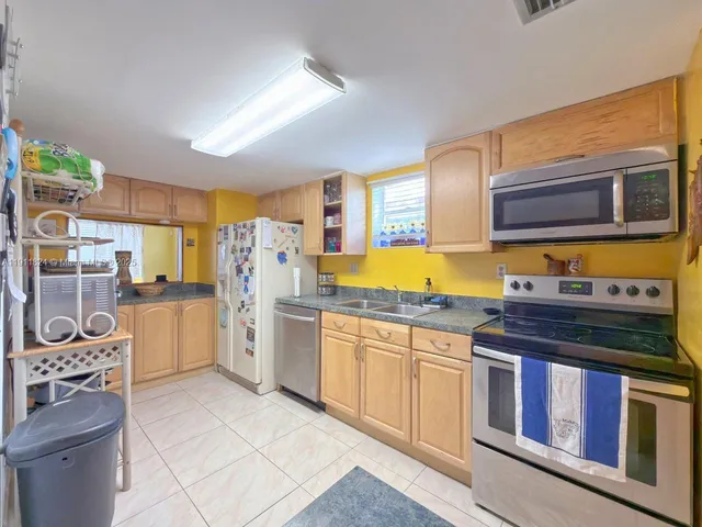 a kitchen with stainless steel appliances granite countertop a stove and a sink